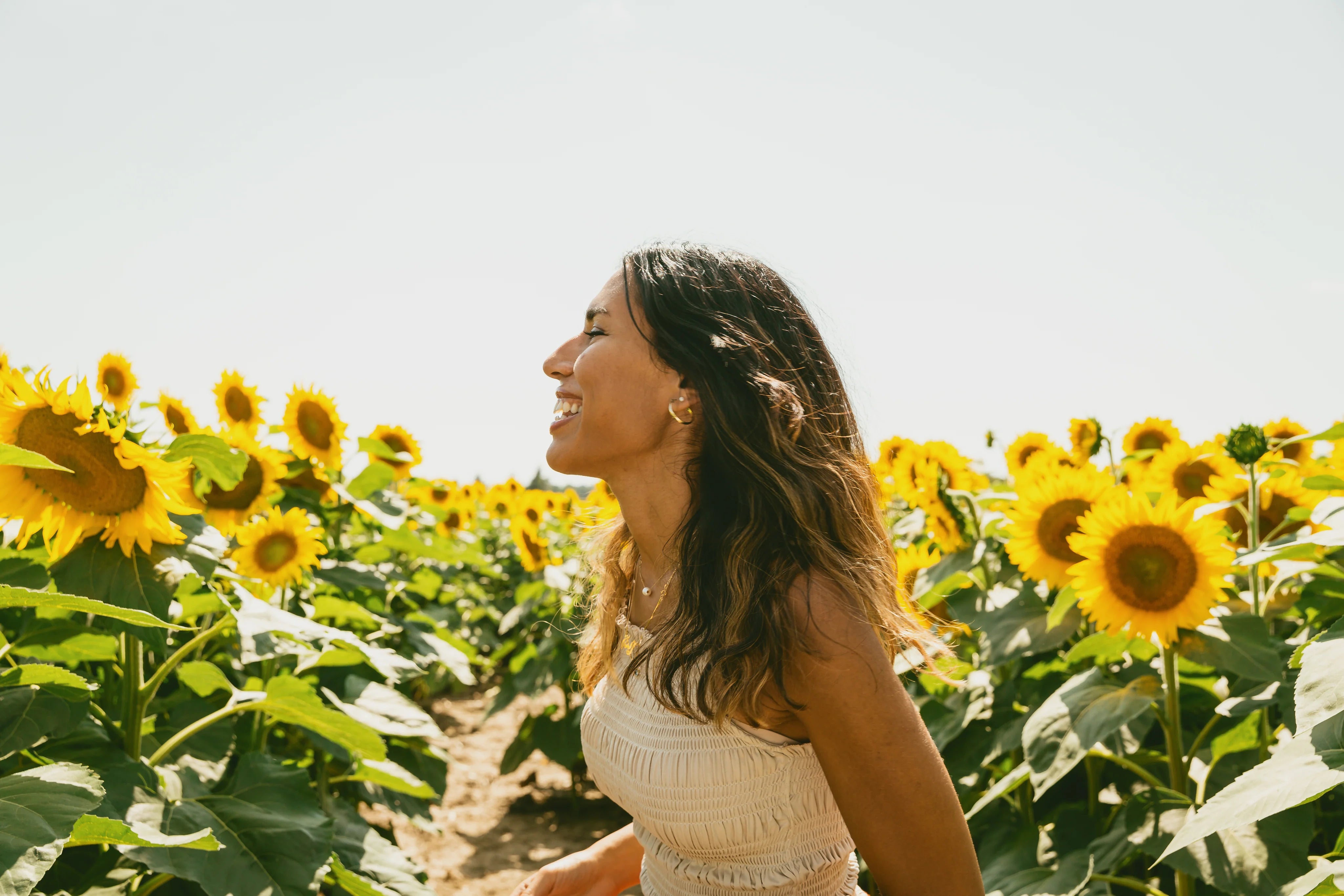 files/profile-of-a-person-smiling-in-a-sunflower-field.webp